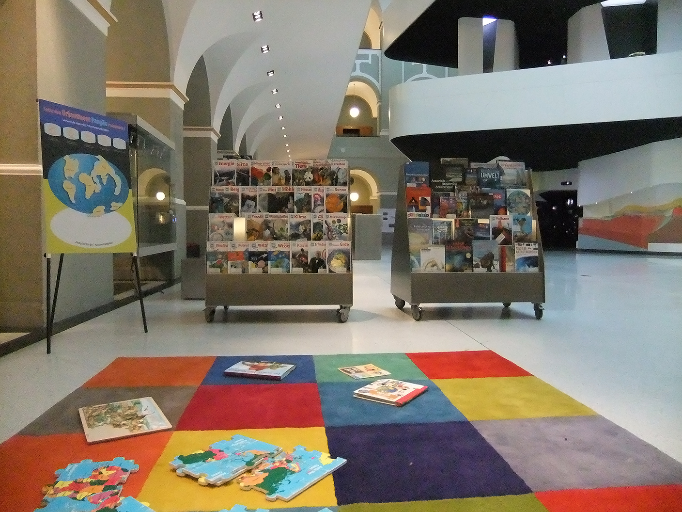 Carpet with books, puzzle in front of the mobile book trolleys
