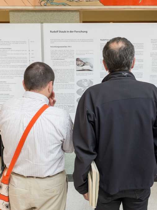 Visitors studying a poster