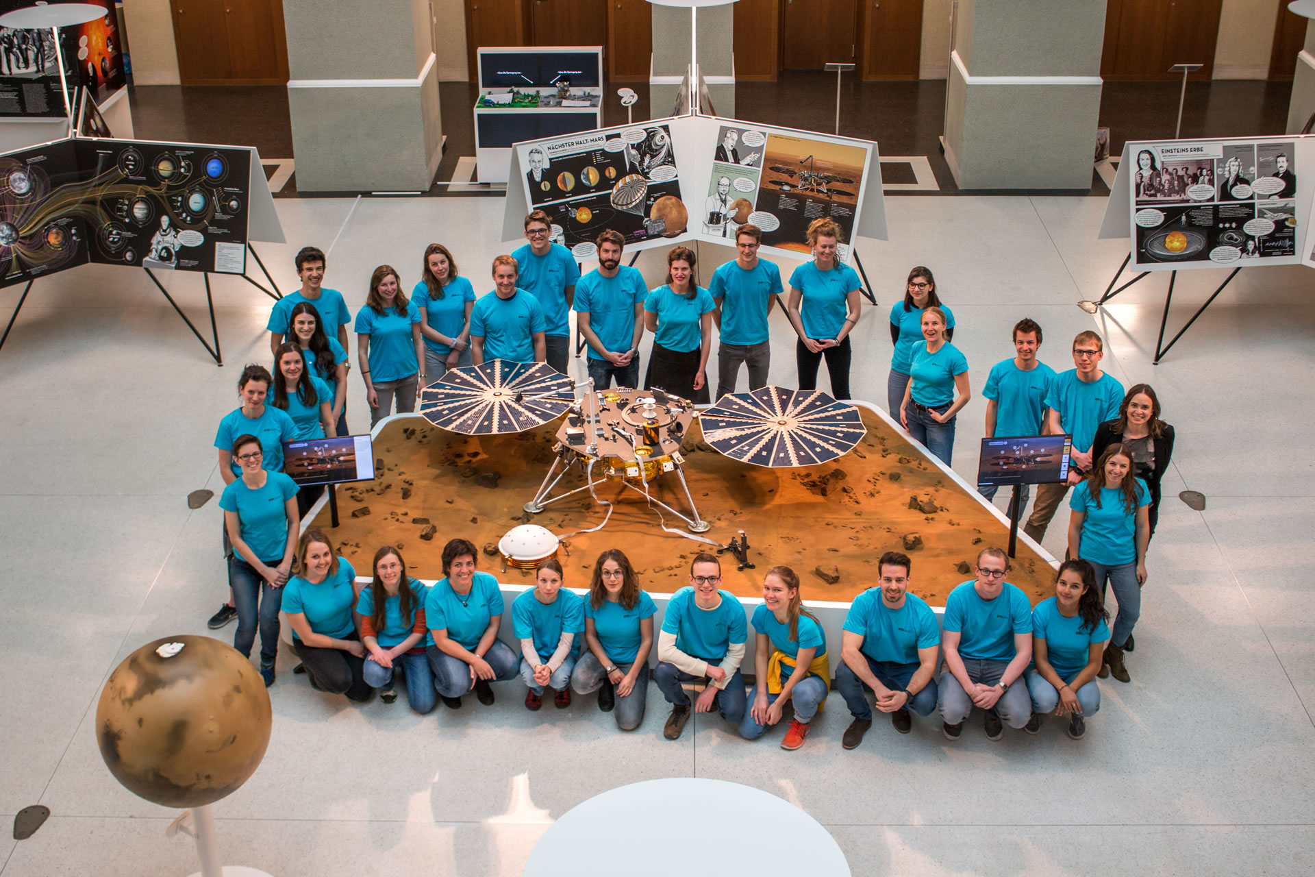 Group picture of focusTerra guides with a model of the Mars InSight lander
