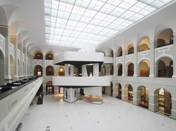 Light atrium in historic building with modern exhibition tower