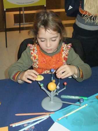 Mädchen erkundet das Sonnensystem (Plastikmodell)